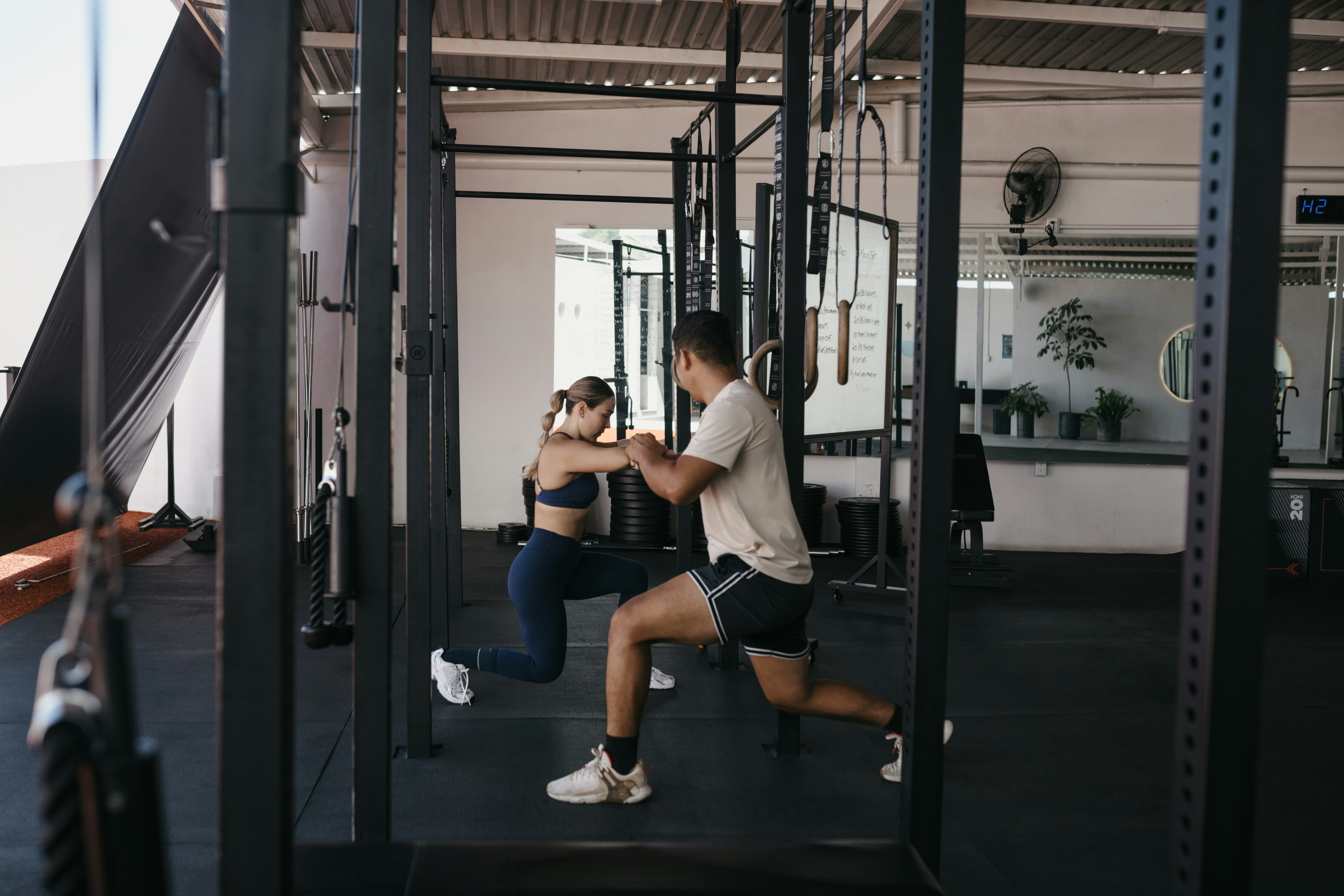 Two athletes training together in a gym